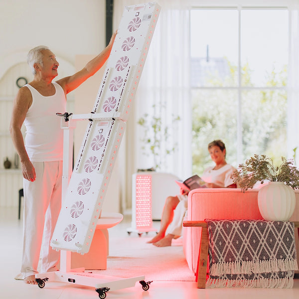 Vrouw stelt de Liroma Multi rood licht therapie lamp in de woonkamer in